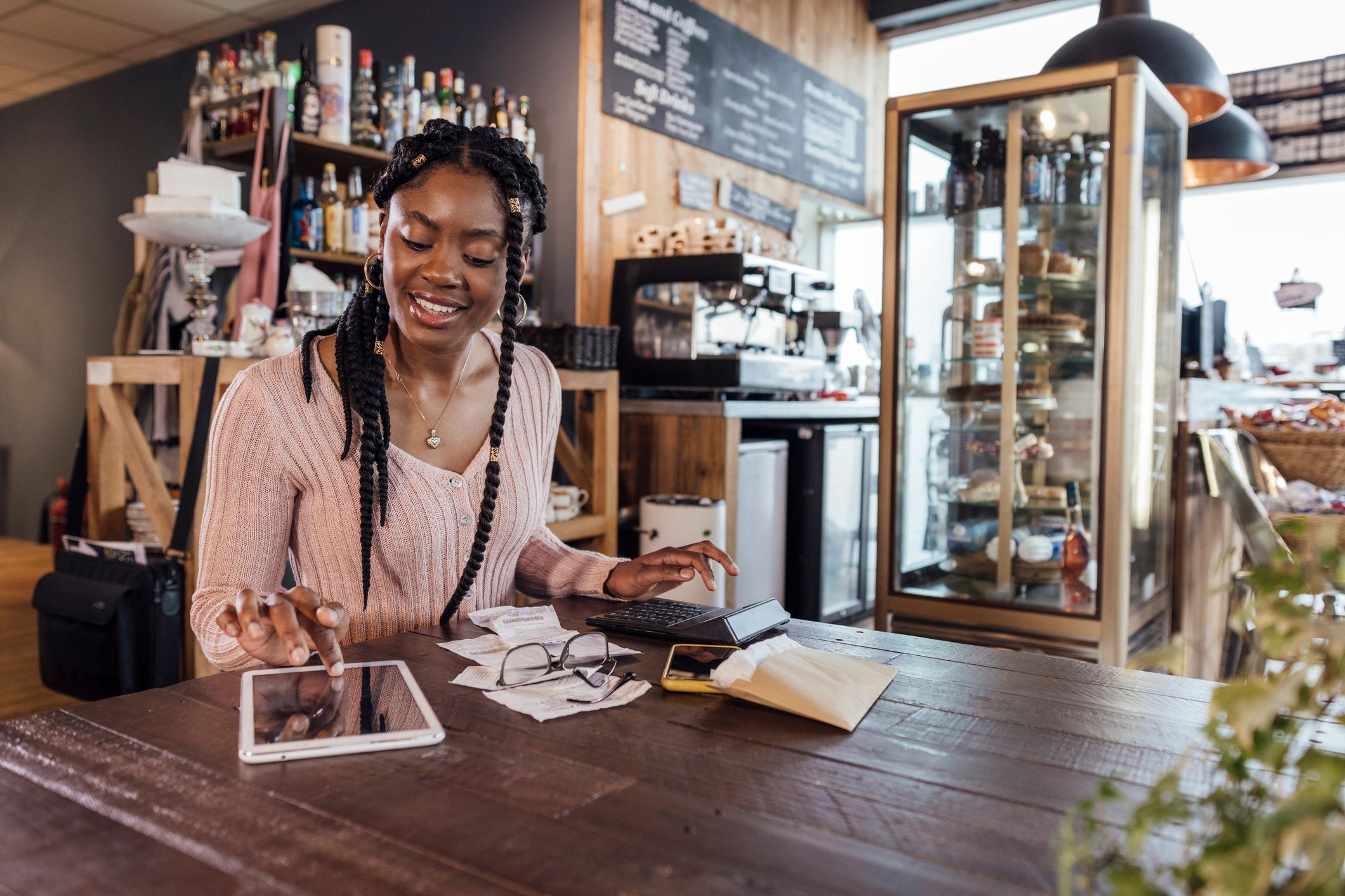 Small business owner reviewing receipts and finances on a tablet