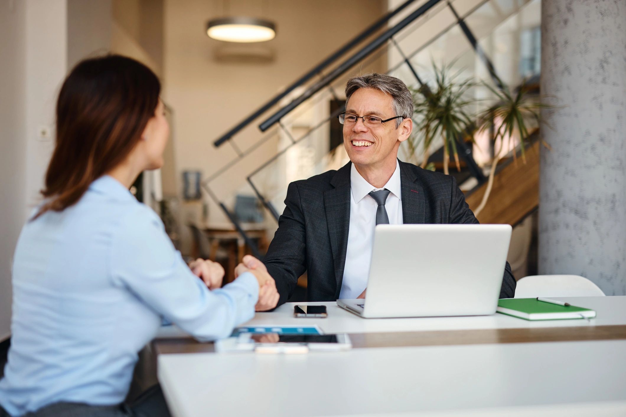 Two professionals shaking hands after a consultation